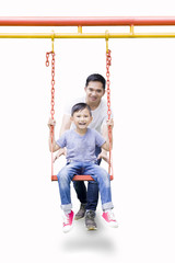 Father with child playing with a swing
