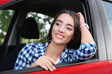 Beautiful young woman in car