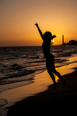 Fototapeta premium woman on beach sunset