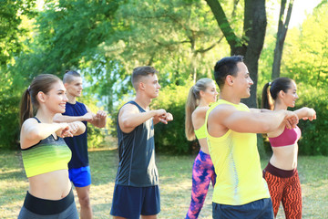 Group of young people doing exercise outdoor