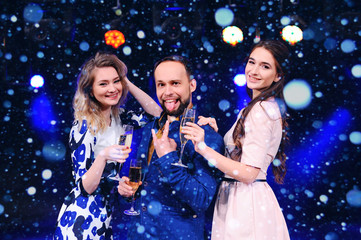 group of friends celebrating new year or Christmas with glasses of champagne in hand