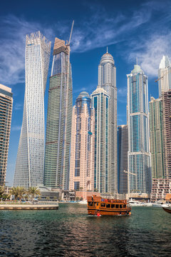 Dubai Marina with boats against skyscrapers in Dubai, United Arab Emirates