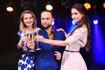 group of friends having fun at the party with a glass of wine or champagne. Holiday, event,...