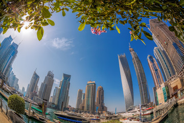 Dubai Marina with boats against skyscrapers in Dubai, United Arab Emirates
