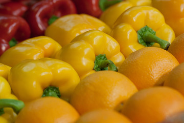 beautiful, tasty and healthy peppers and oranges in the shop window
