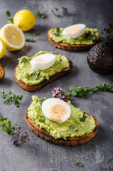 Bio avocado on bread with boiled egg