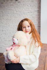 beautiful red-haired girl with Teddy bear