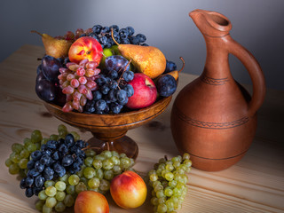 autumnal fruit still life with Georgian jug on rustic wooden table background