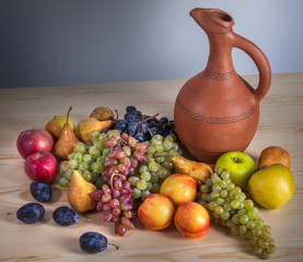 autumnal fruit still life with Georgian jug on rustic wooden table background