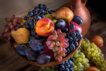 autumnal fruit still life with Georgian jug on rustic wooden table background