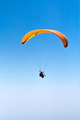 Sky Diving with space in solid blue sky