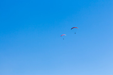 Sky Diving with space in solid blue sky