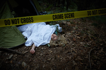 crime scene, woman playing dead, lying on the ground