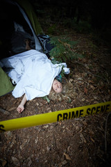 crime scene, woman playing dead, lying on the ground
