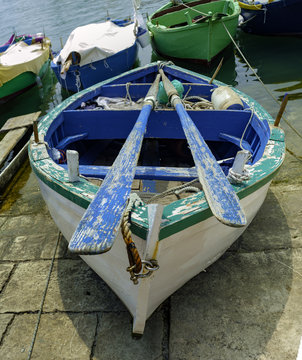 Close up of "gozzo", characteristic puglia boat, on the mainland with its leaning ranks