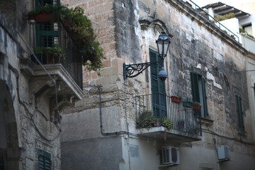 Stylized antique lantern on the front wall of an old residential building. Lecce, Italy.