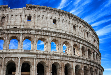 Fototapeta na wymiar Colosseum famous architectural monument close-up in the daytime on the clouds background. Rome, Italy.