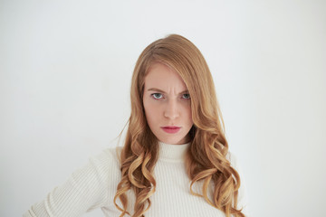 Picture of serious angry adult woman with blue eyes and curly hair frowning feeling furious,...