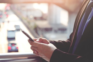 close up of businessman using telephone check Traffic condition pass through application.