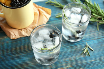 Glasses with fresh rosemary drink on table