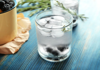 Glass with fresh rosemary drink on table