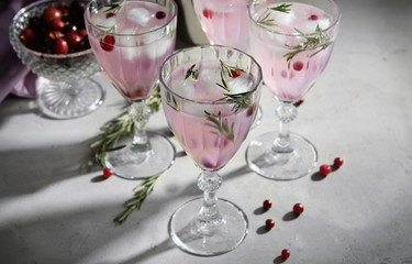 Glasses with fresh rosemary drink on table