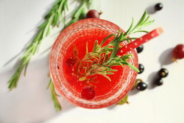 Glass with fresh rosemary drink on table