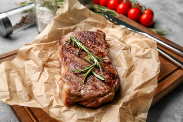 Tasty grilled steak on wooden board