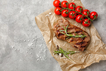 Tasty grilled steak on table