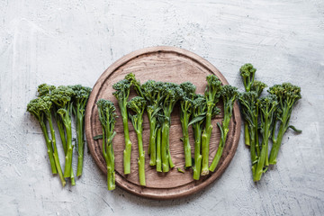 Broccolini, broccoli florets green vegetable broccolini grows baby broccoli vegan food grey table overhead