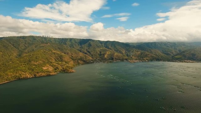 Fish Farm with floating cages in lake Taal. Aerial view: Fish farming with cages for whitebait on the surface of the water. Luzon, Philippines.