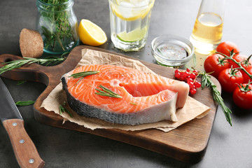 Fresh salmon steak on wooden board