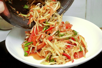 Thai popular recipe, Spicy and sour mixed vegetable salad with papaya roll call Som Tum in Thai topped french fried strick ,lentils and morning glory.