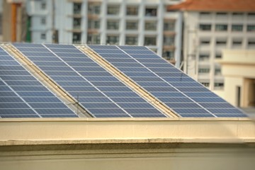 Solar Panels on building's roof In modern city. Technology concept. Soft focus with blurred background.
