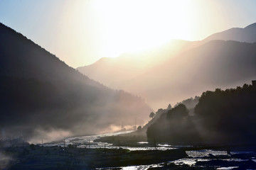 Sunny dawn on the background of a mountain river in the mountains.