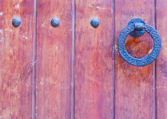 Door with brass knocker in the shape of a decor,  beautiful entrance to the house