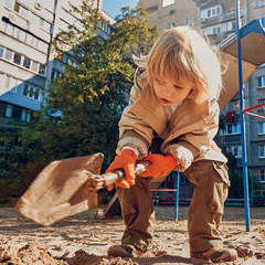 cute Boy playing with sand