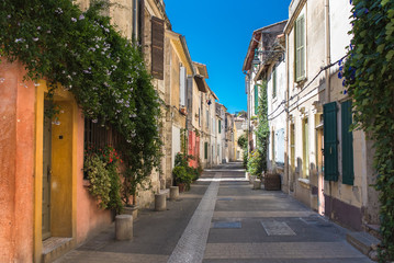 Fototapeta na wymiar Arles in the south of France, typical paved side street of the city center 