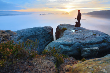 Sharp rear man silhouette on rocky peak. Satisfy hiker enjoy view. Tall man on rocky cliff