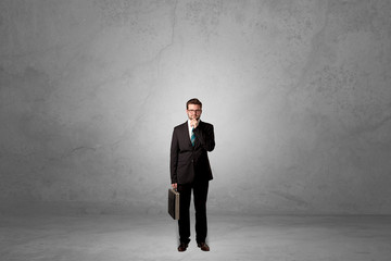 Fototapeta premium Alone businessman standing in a dark room