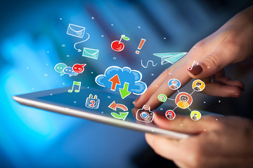 Fingers touching tablet with social icons