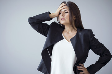 Unhappy businesswomen on the grey background