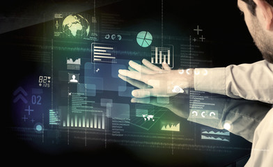 Businessman touching interactive modern desk with technology icons