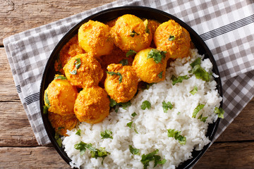 Indian food: Dum aloo potatoes in a sauce with rice close-up. horizontal top view