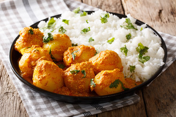 Indian curry potatoes Dum aloo in sauce with rice close-up. horizontal