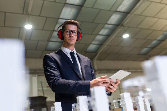 Confident supervisor inspecting factory