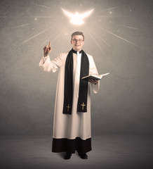 young priest in giving his blessing
