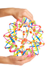 colored transformer ball in hand isolated on white background