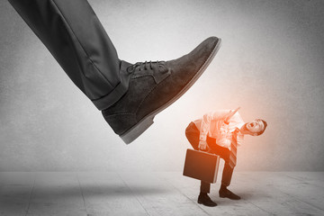 Large foot stepping down small man