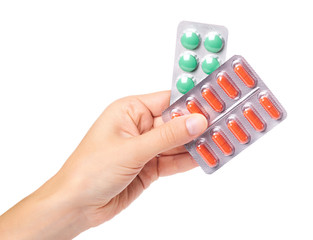 medical pills in blister in hand isolated on white background